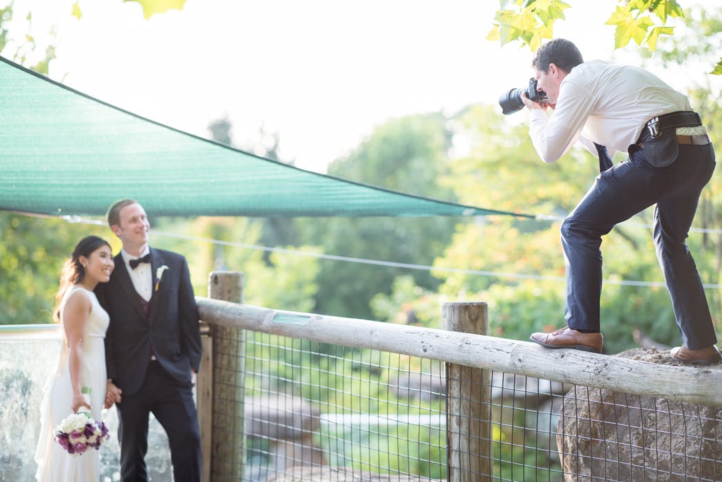 wedding photographer taking photos of the newly wed